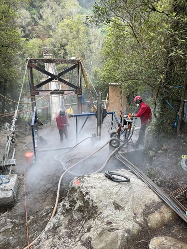 Shea Croft and Roydon Dick drilling new anchors for new Hokitika Gorge swing bridge